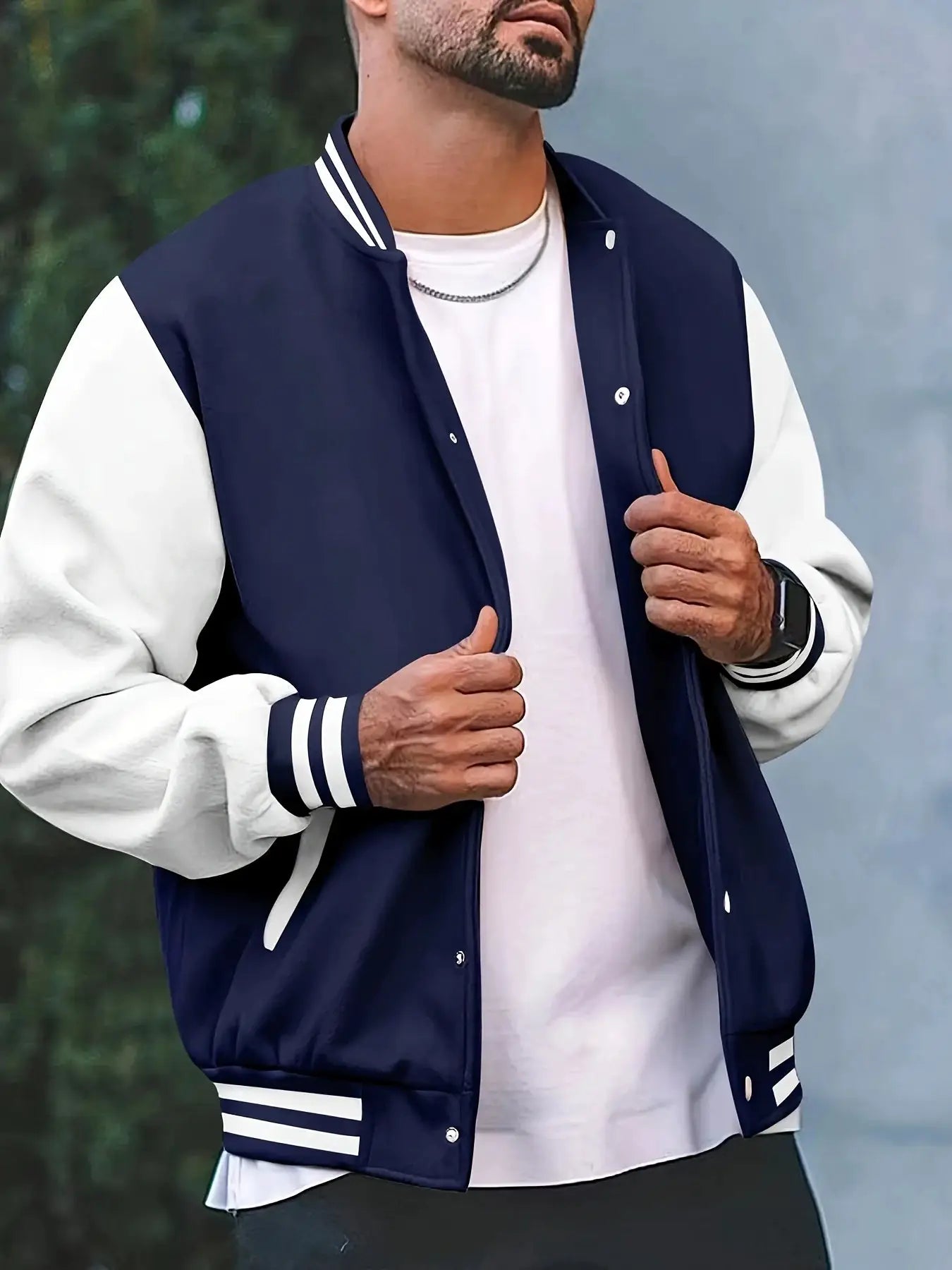 Men's navy baseball jacket with white sleeves, striped cuffs and collar, front snap buttons.