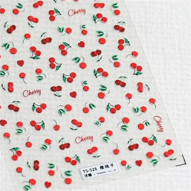 Nail art stickers sheet featuring red cherries and green leaves, self-adhesive decals for manicure