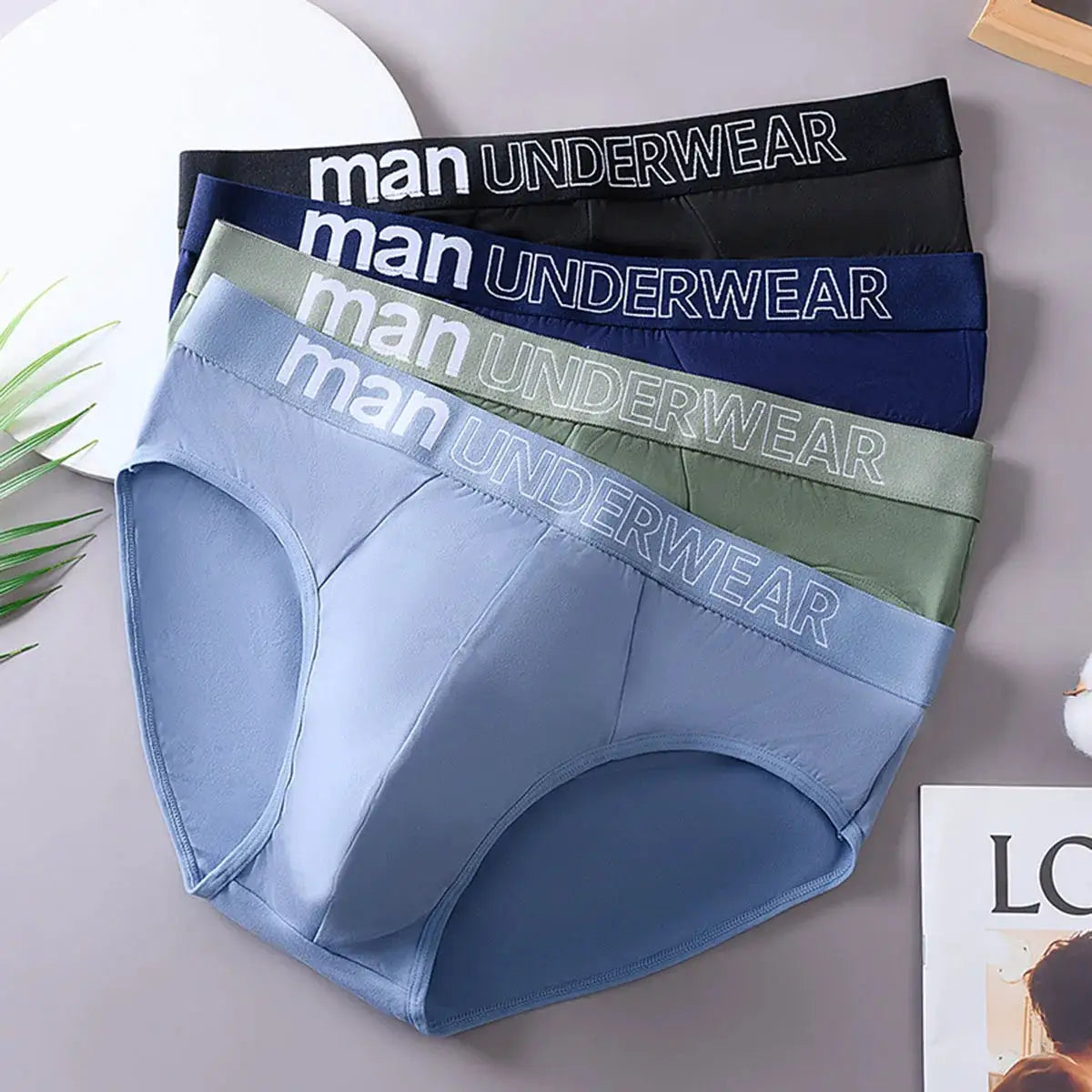 Men's underwear briefs by Simples Market, 3-pack, with MAN UNDERWEAR waistband in assorted colors; soft stretch fabric.