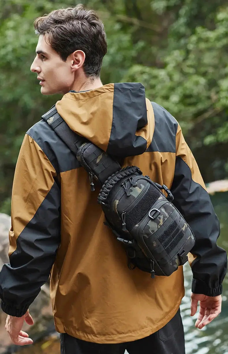 Tactical chest bag with MOLLE system, camouflage pattern, worn crossbody by a man in an outdoor jacket