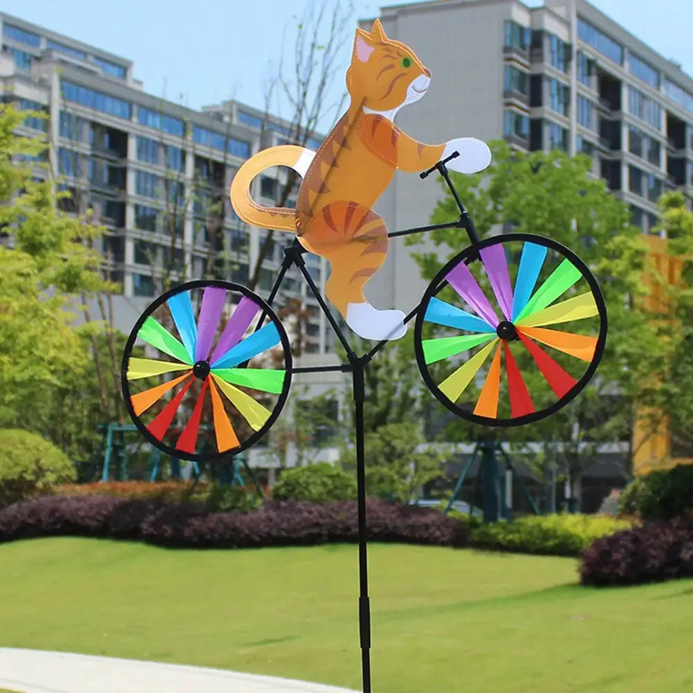 Cat riding wind spinner by Simples Market on a standing pole with rainbow color wheels