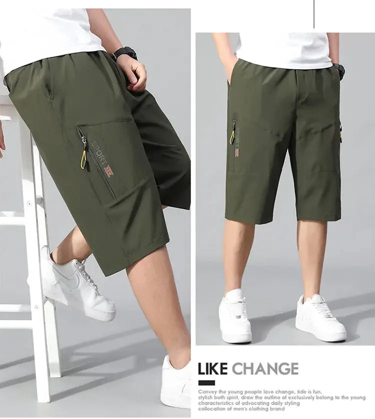 Men's olive cargo shorts, knee-length with zippered side pocket and elastic waistband.
