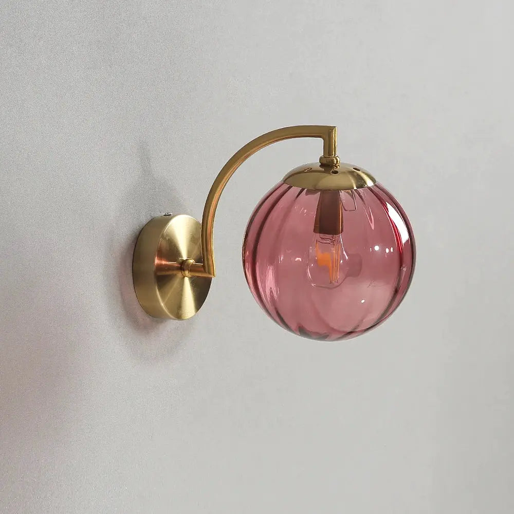Wall sconce LED lamp with brass finish and pink glass globe by Simples Market