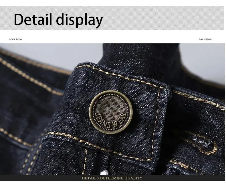 Men's dark denim jeans close-up with brass button and yellow contrast stitching.