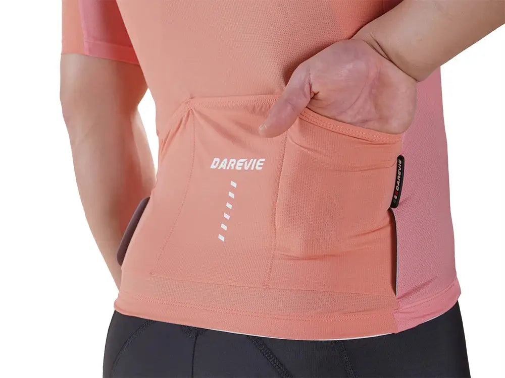 DAREVIE cycling jersey peach pink with back pocket and breathable quick-dry fabric.