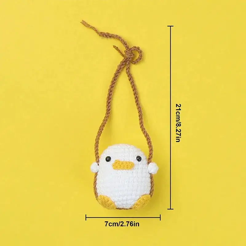 Crochet duck frog car pendant by Simples Market; white body with yellow beak/feet, brown cord, 21 cm long