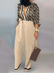 Women letter-print long-sleeve jumpsuit by Simples Market with beige wide-leg trousers and belt.