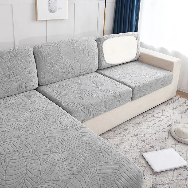 Simples Market waterproof stretch sofa slipcover in gray leaf-patterned fabric on a sectional couch