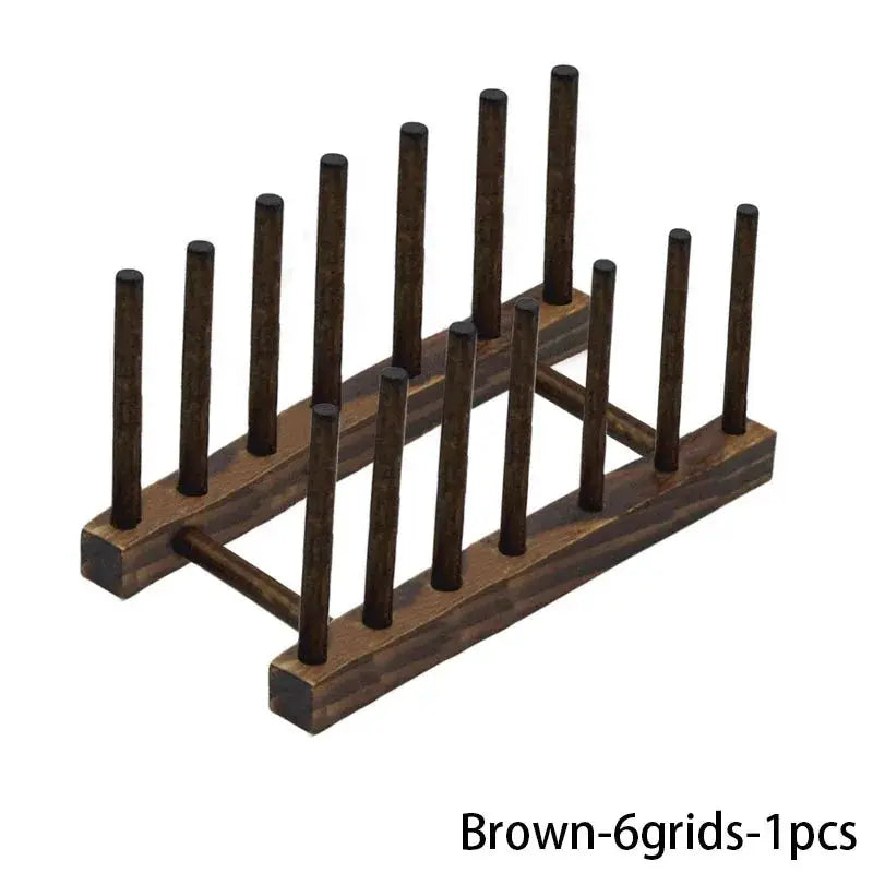 Brown wooden dish drying rack with multiple vertical pegs for draining tableware.