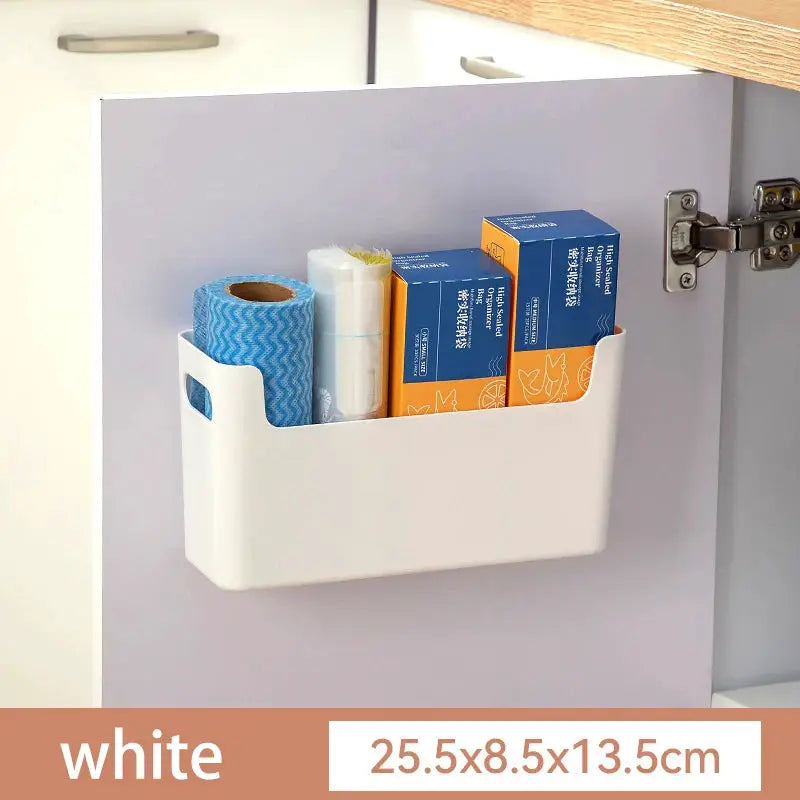 White plastic inside-cabinet rack for cling film and wraps, mounted on a kitchen cabinet door.