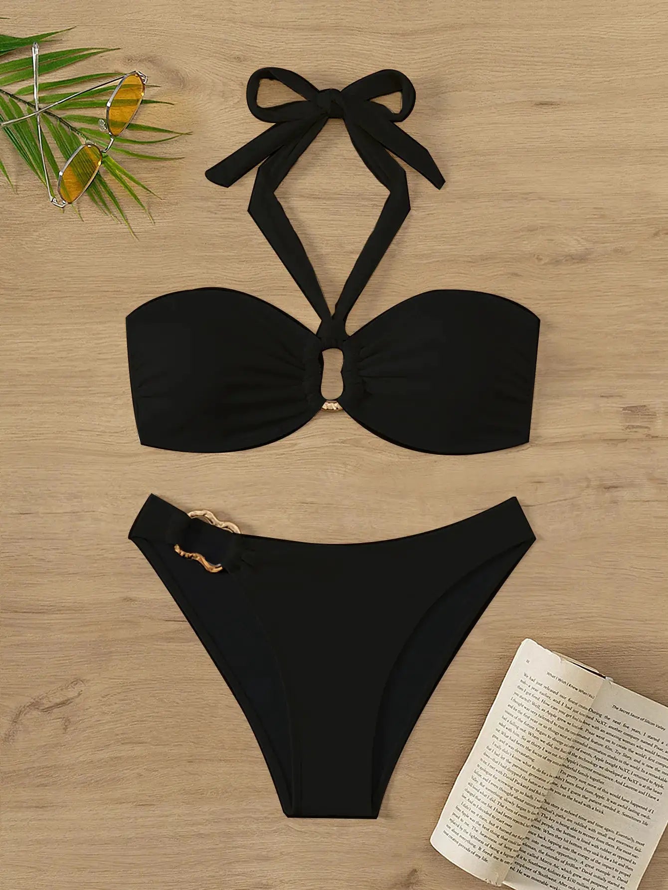 Two-piece black bandeau push-up bikini with halter-neck straps and high-cut thong bottoms