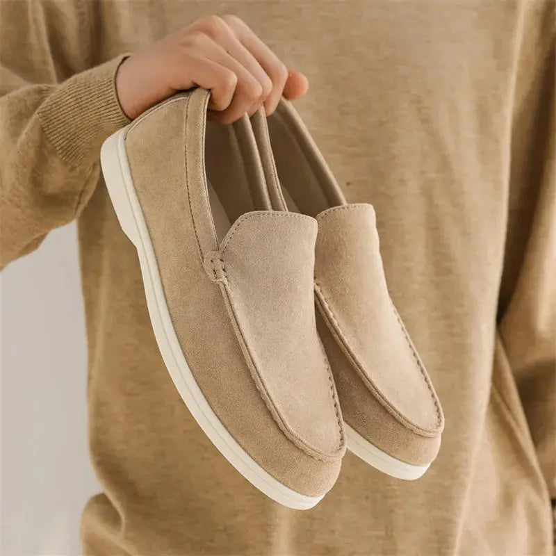 Pair of men's tan suede loafers, slip-on moccasin-style driving flats with white sole