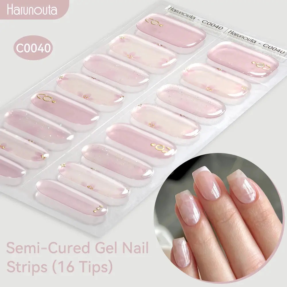 Harunouta gradient auroras semi-cured gel nail strips, 16 pink glitter tips with gold accents.