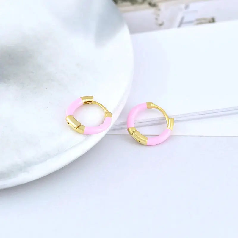 Pair of pink hoop earrings with gold-tone caps and pink enamel segments