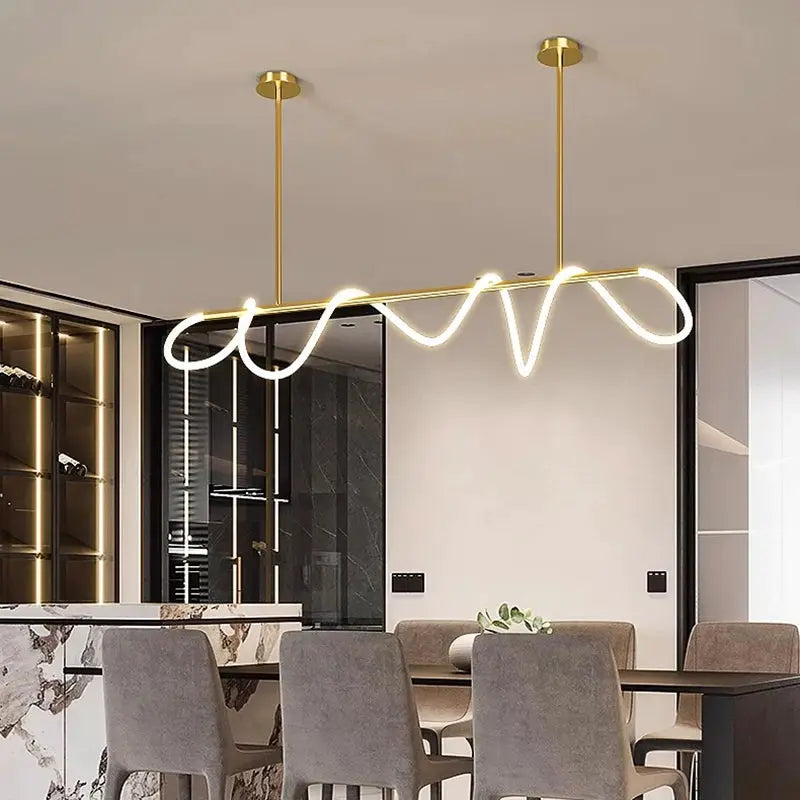 Nordic gold pendant chandelier with a wavy white neon LED tube, suspended by two gold rods over a dining table.