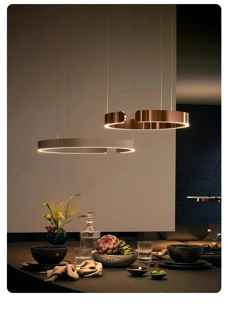 Nordic Ring LED pendant lamps, black and gold, dimmable, two hanging circular lights over a dining table