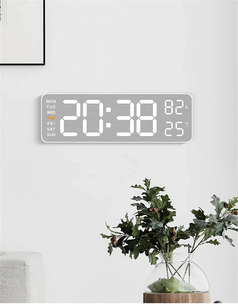 Mirror-brushed finish wall clock with large digital display showing time, humidity and temperature.