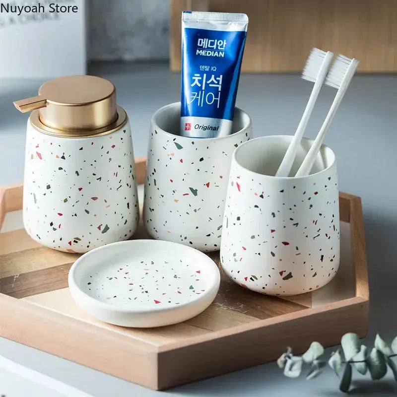 European Bathroom Decoration Set, speckled terrazzo ceramic with emulsion bottle, gargle cup, and soap dish on a wooden tray