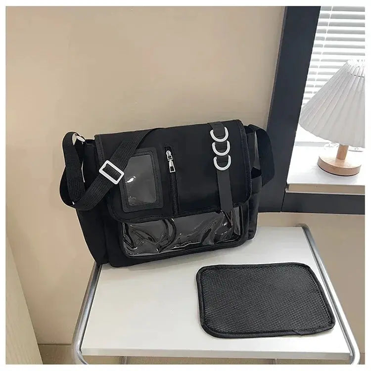 Black Y2K Harajuku Ita bag with clear front panel, zip pockets, and adjustable shoulder strap