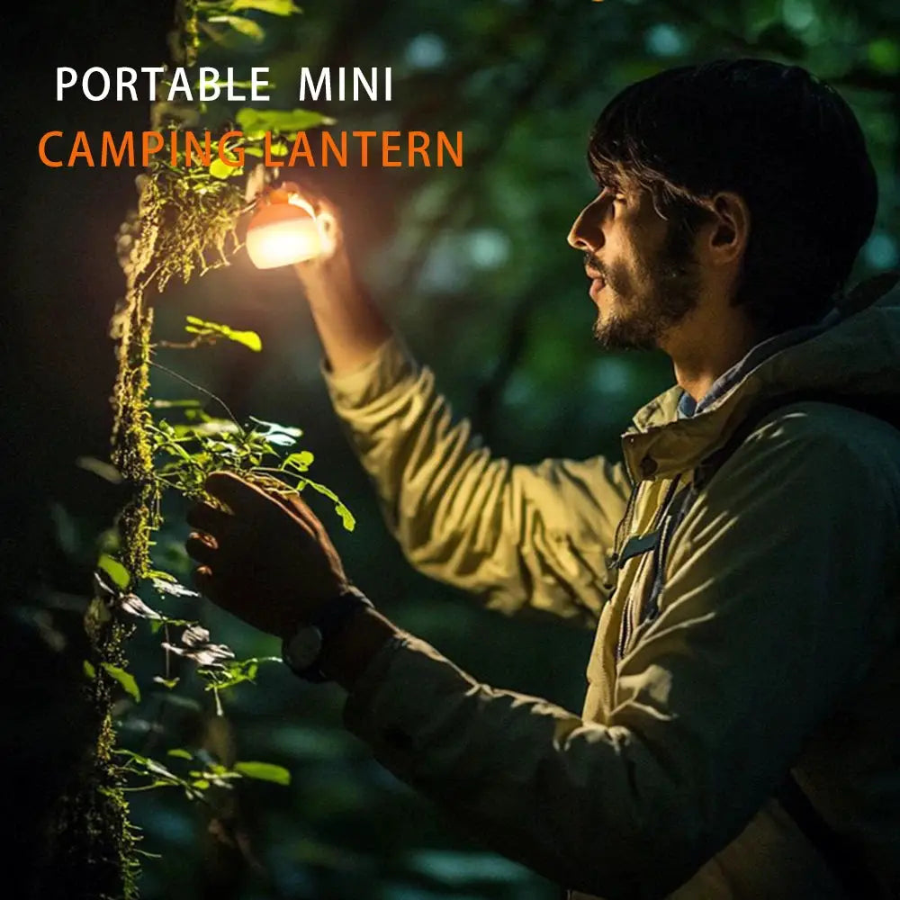 Portable mini camping lantern USB rechargeable with hanging hook, warm glow for outdoor camping at night.