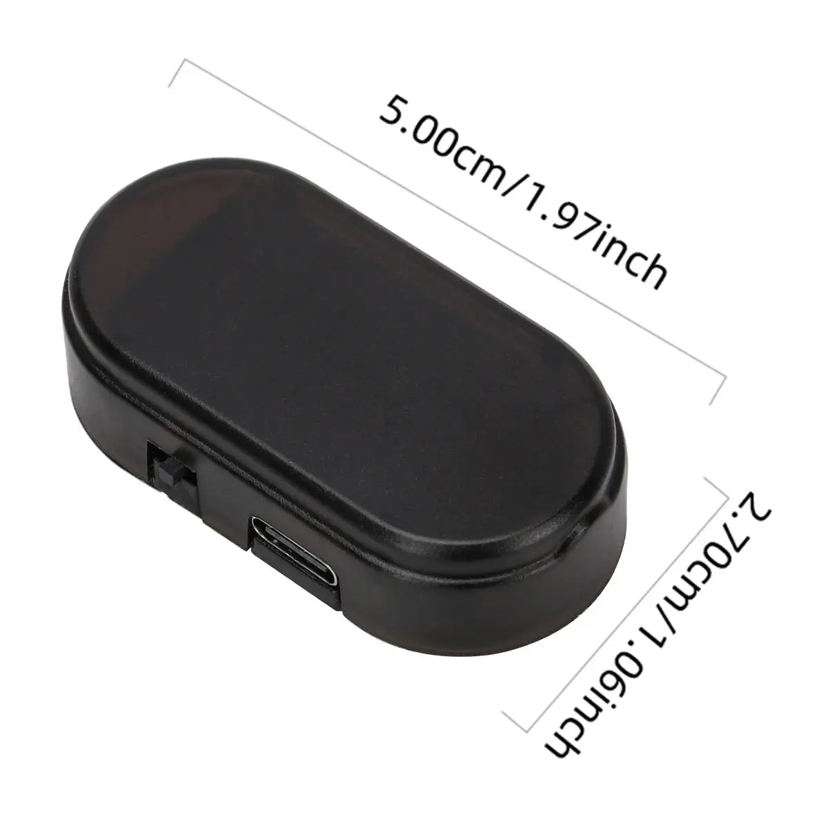 Solar-powered car security light module, black plastic, compact oval shape.