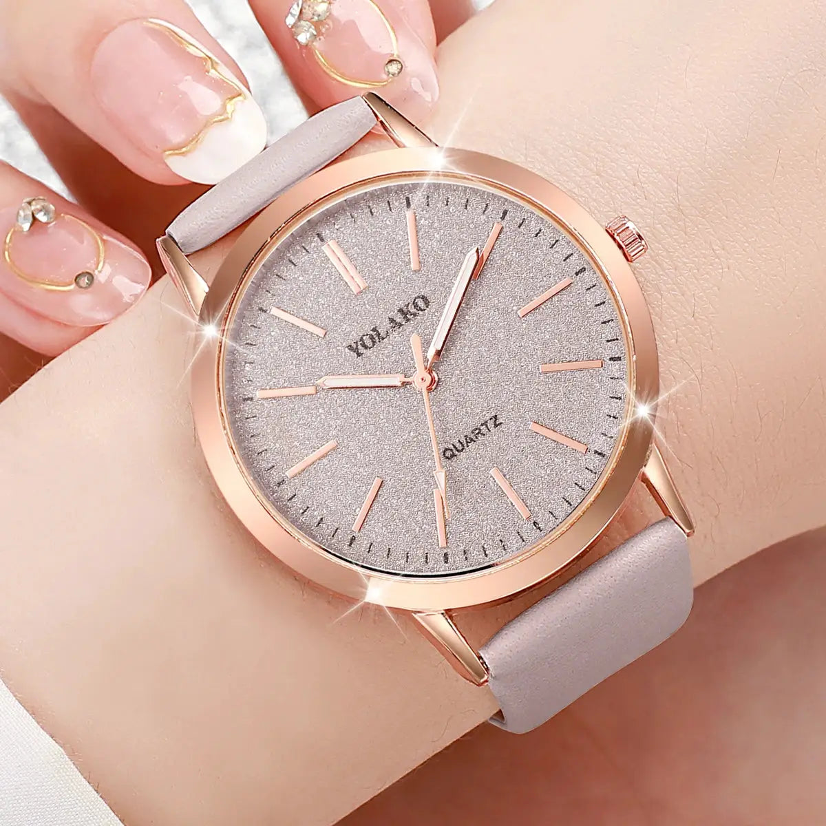 Two-piece women's watches set with rose-gold tone case, grey leather strap, and glitter silver dial (analog quartz).