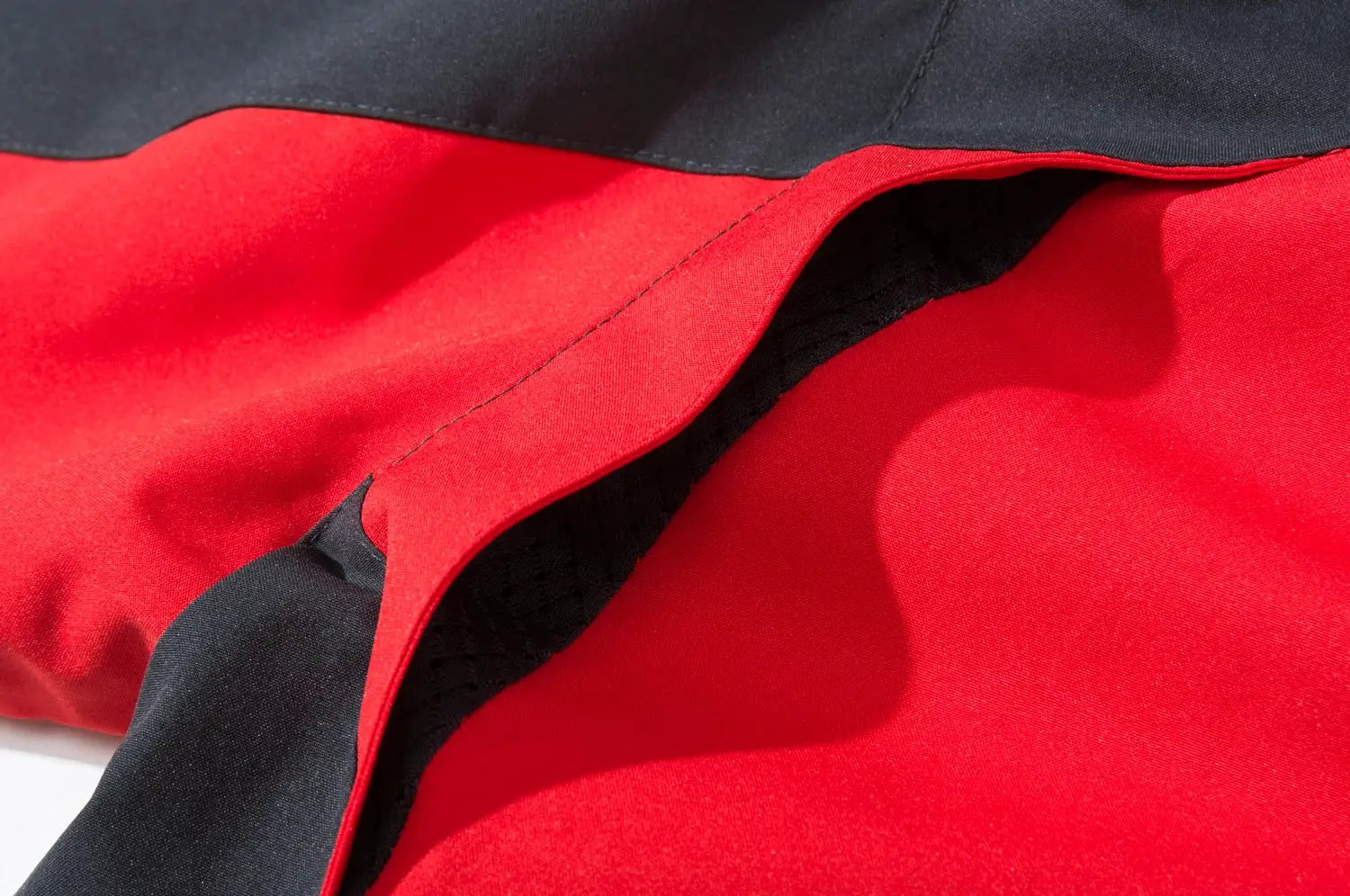 Men's waterproof hiking jacket with red inner lining and black outer shell