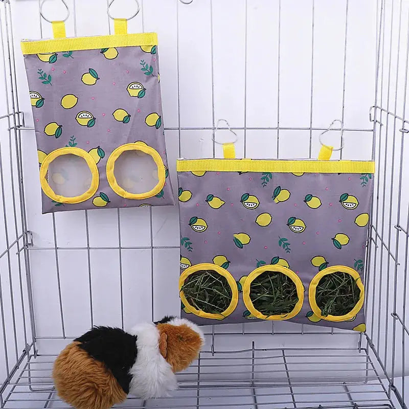 Two rabbit hay bags by Simples Market, gray fabric with yellow trim, 2/3-hole hanging feeders for small pets.