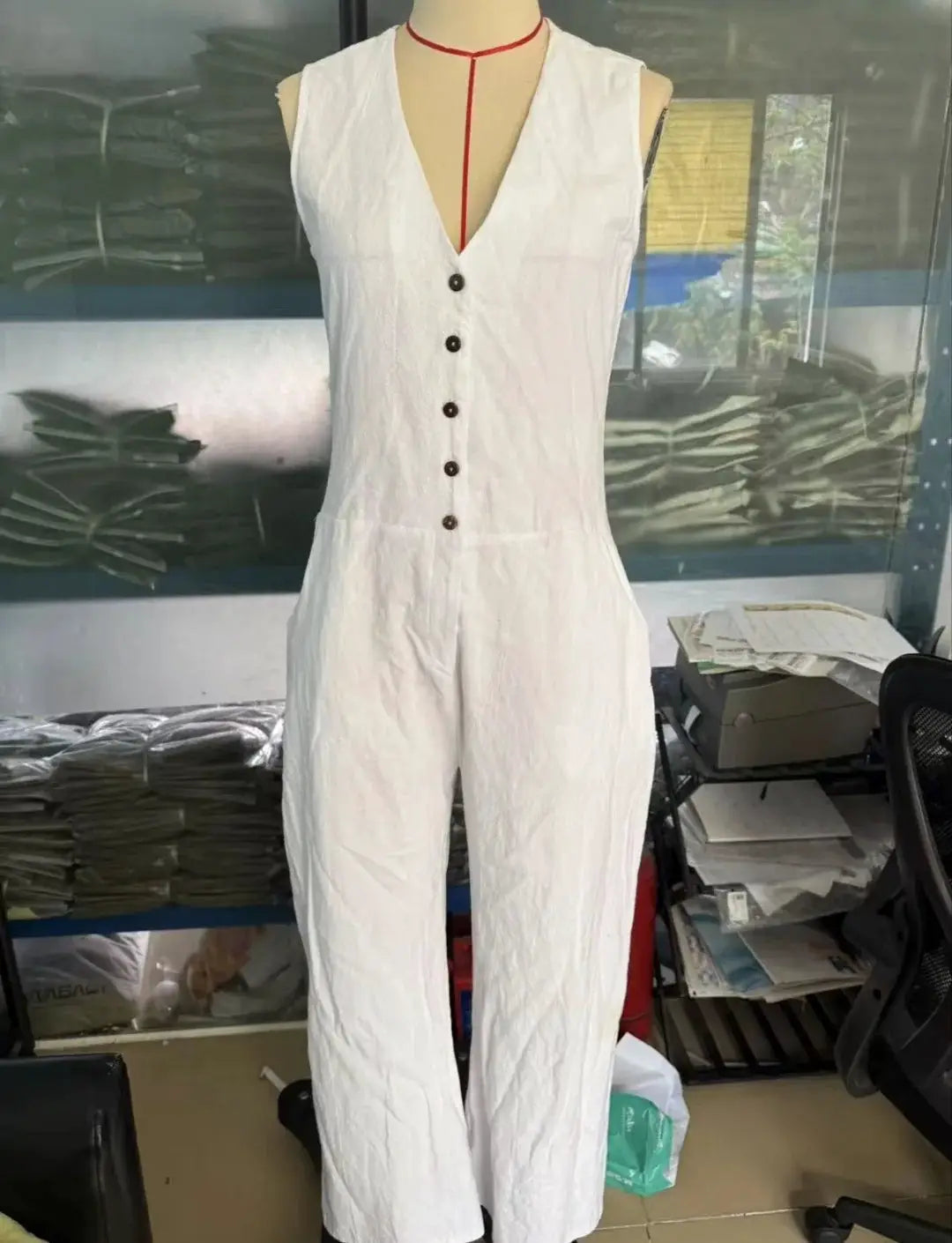 Simples Market sleeveless V-neck white jumpsuit with button front and pockets, loose wide-leg fit