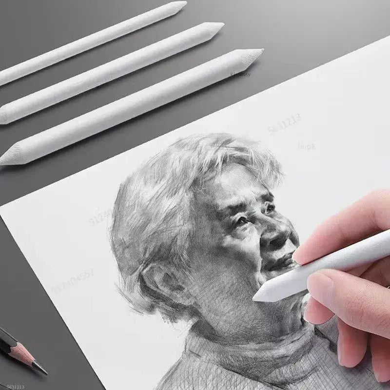 Sketching pen set with white drawing pens; hand sketching a portrait on paper.