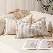 Summer boho striped pillow covers 30x50 set of 2 with fringed edges on a beige sofa