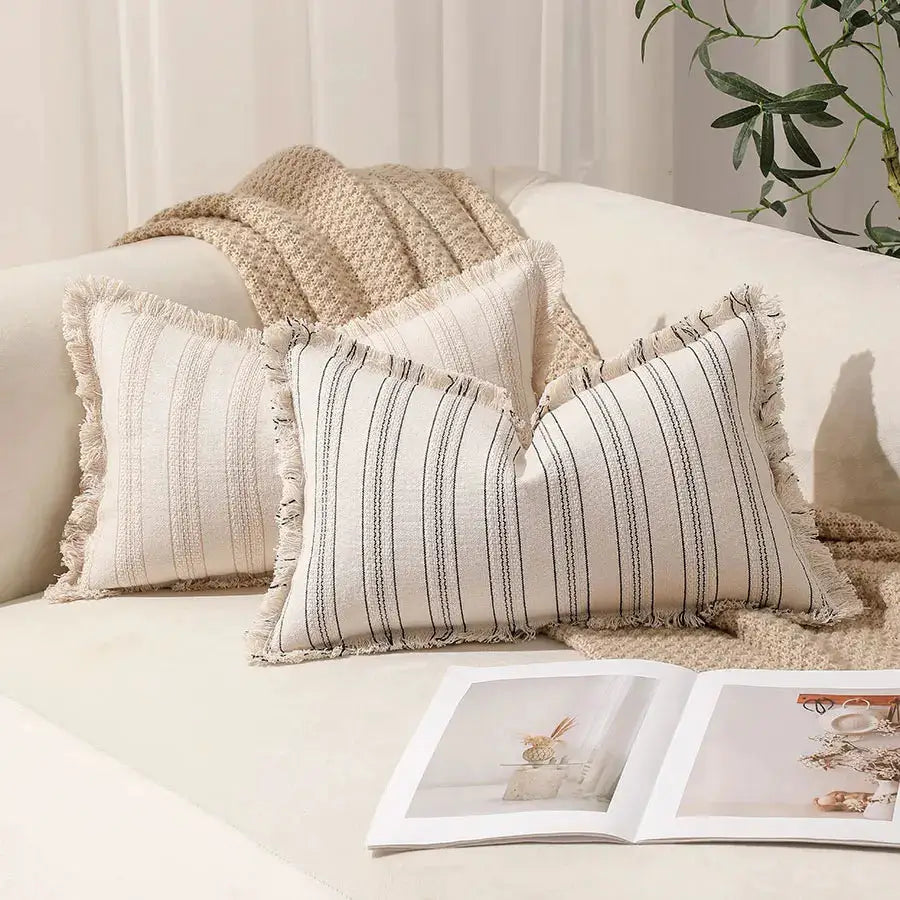 Summer boho striped pillow covers 30x50 set of 2 with fringed edges on a beige sofa