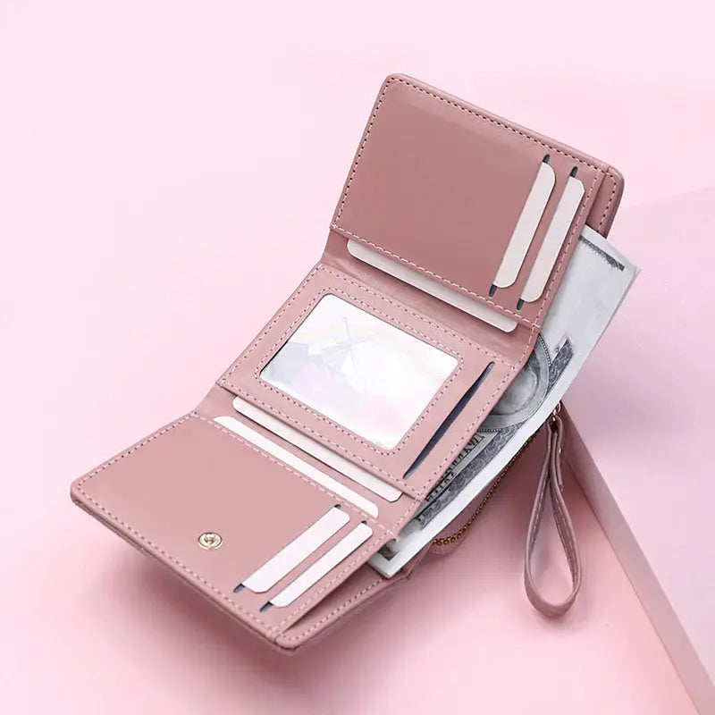 Women's pink PU tri-fold wallet with card slots, ID window, and cash pocket