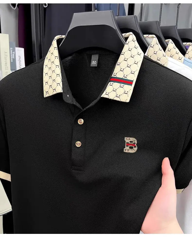 Men's black polo with beige patterned color-block collar and embroidered B logo on chest.