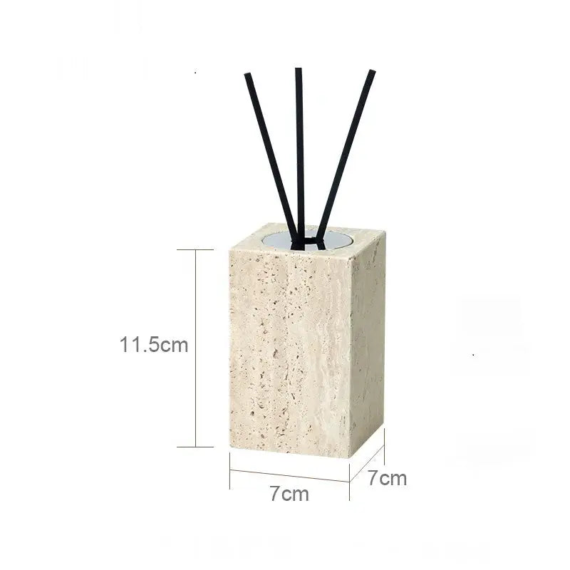 Beige travertine bathroom diffuser with black reeds; natural stone block, 11.5 cm tall and 7 cm square.