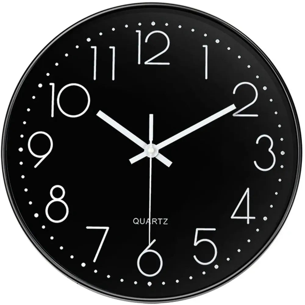 Wall clock, black round with white numerals, dotted minute markers, and silver hands.