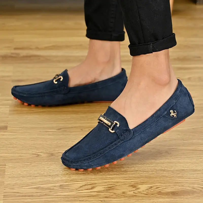 Pair of navy suede YRZL loafers for men by Simples Market with gold buckle detail and orange studded sole