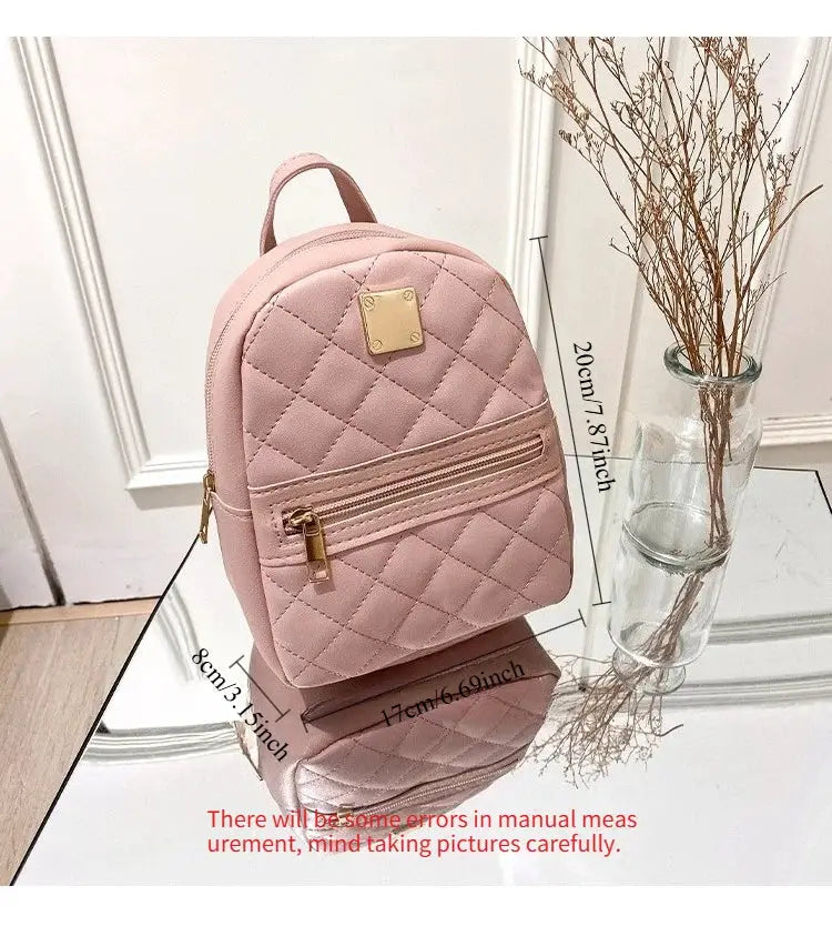 Embroidered pink quilted backpack by Simples Market with front zip pocket and gold hardware