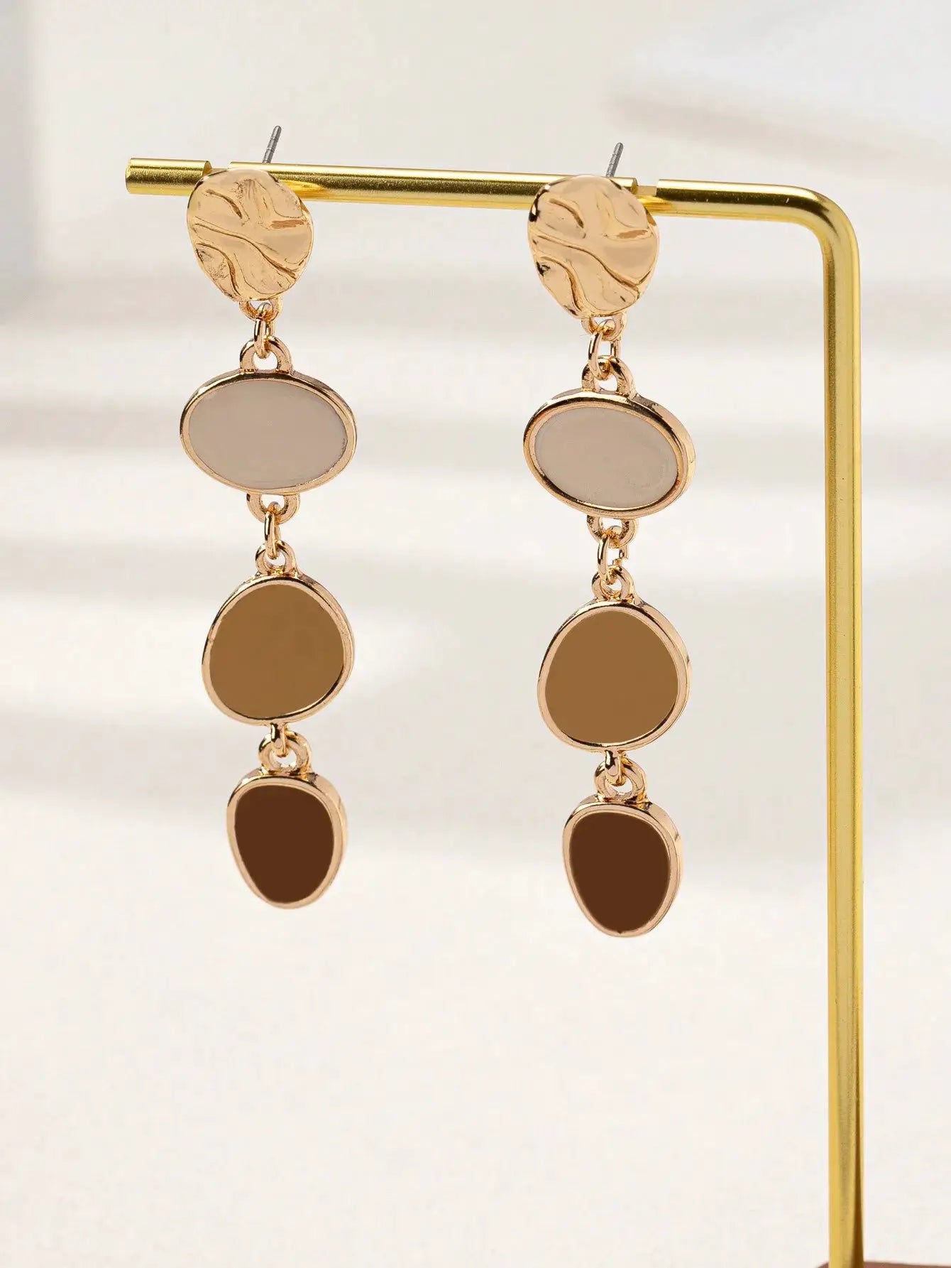 Simples Market gold-tone drop earrings, a pair with three linked oval beige and brown discs, textured top studs