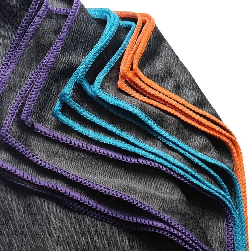 Lint-free cleaning cloths with purple, blue, and orange edging for glass windows and kitchen use.