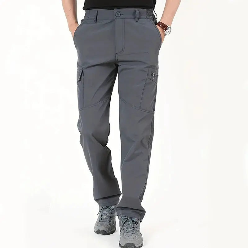 Men's outdoor work tactical pants in gray; fleece-lined, waterproof cargo trousers for hiking and travel.