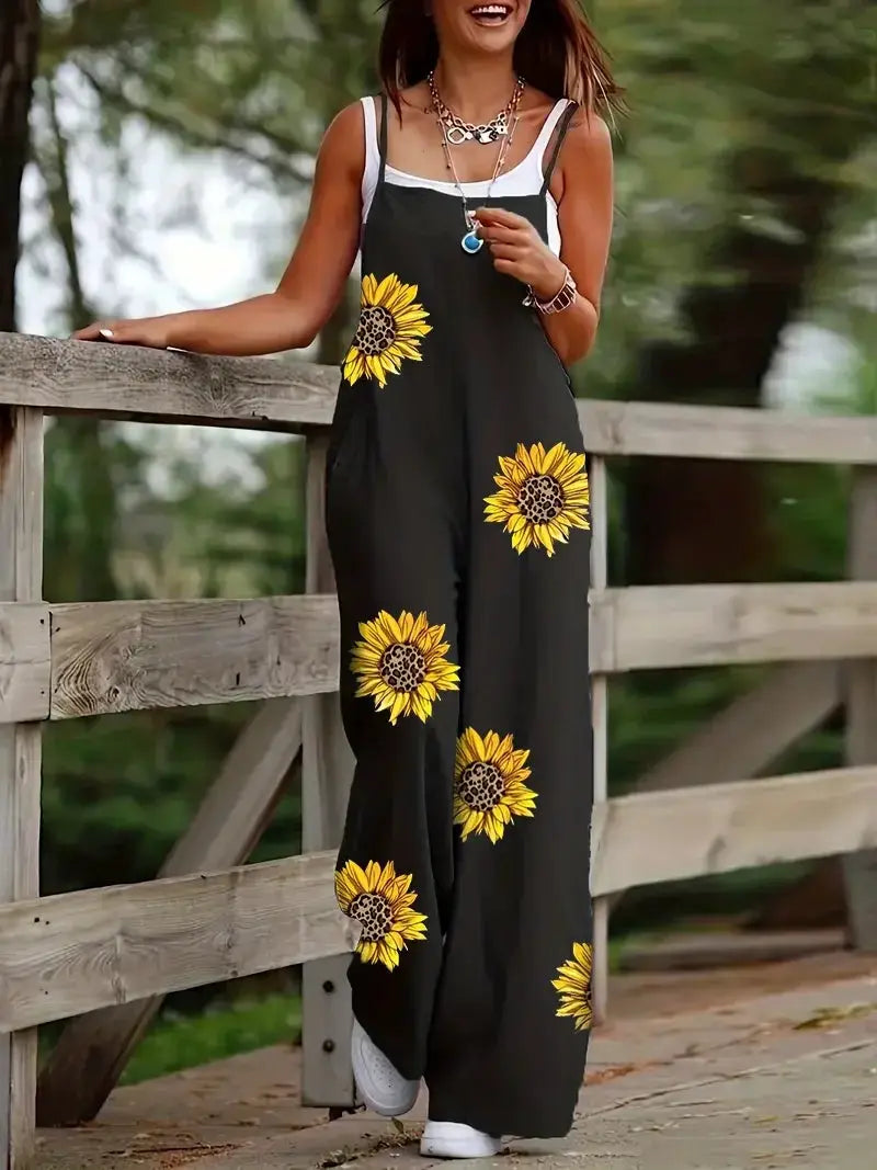 Women's sleeveless jumpsuit with suspenders, black wide-leg pants featuring bright sunflower prints and pockets