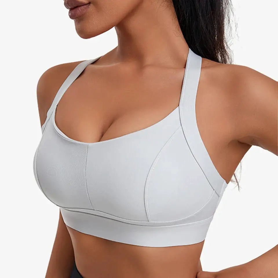 Women high-impact padded sports bra in light gray with criss-cross back straps