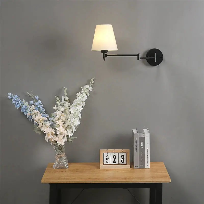 Nordic LED adjustable folding wall lamp by Simples Market, with black metal arm and white fabric shade, wall plate.