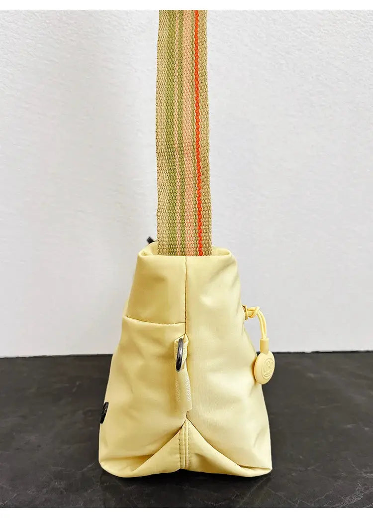 Ultra-light nylon crossbody bag for women with adjustable wide strap and zipper closure.
