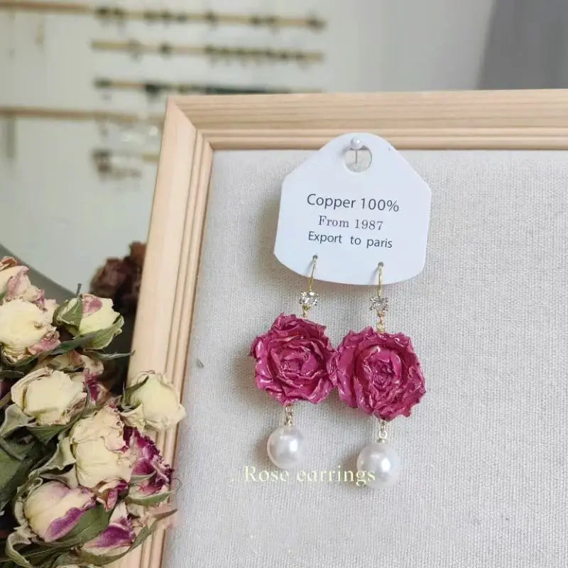 Rose earrings pair; pink epoxy-resin rose blooms with pearl drop dangles