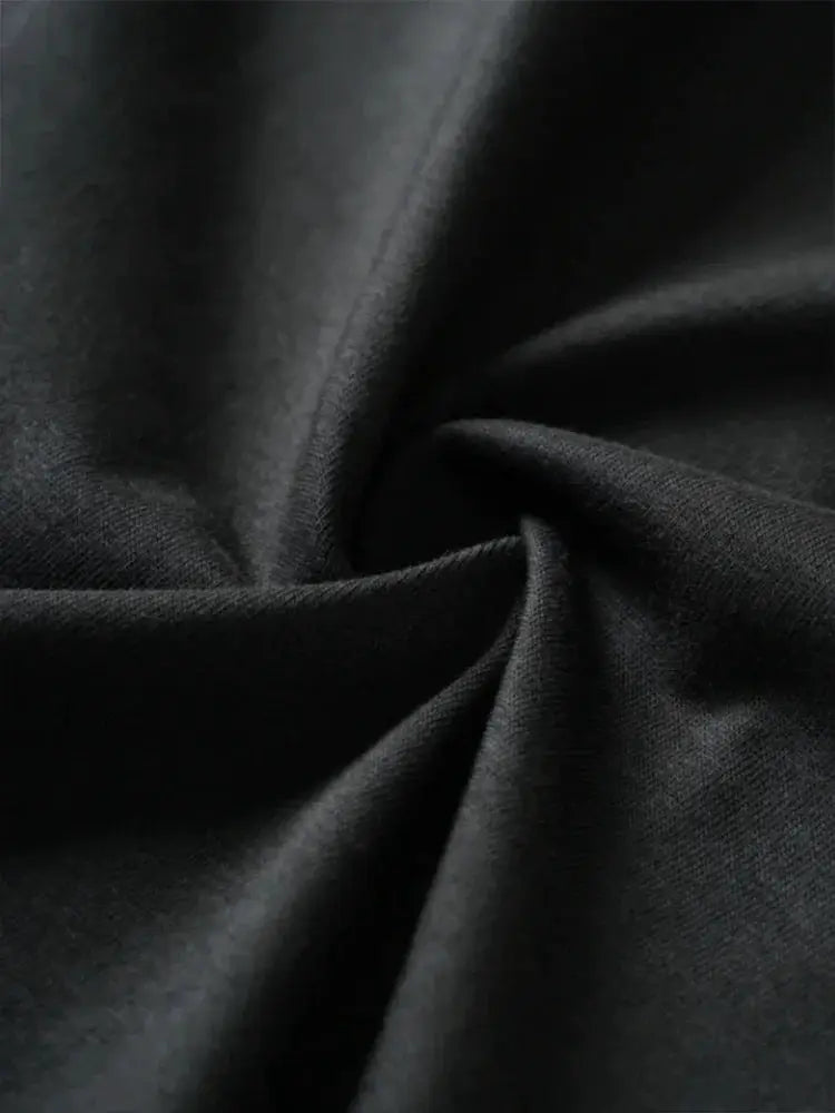 Cycling sweatpants fabric close-up in black; stretch material, soft texture.