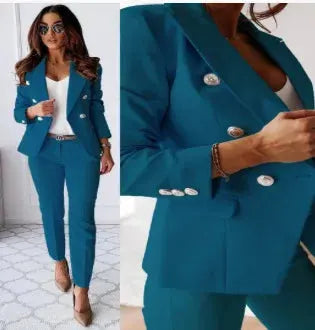 Women's teal office two-piece suit with V-neck blazer and matching trousers, silver buttons.