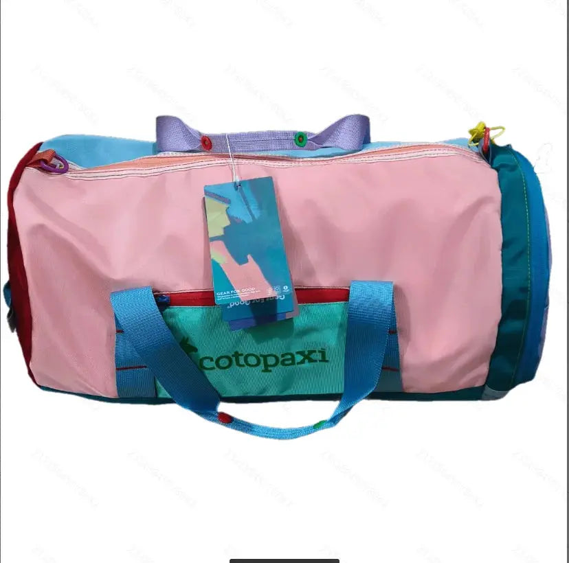 Cotopaxi nylon tote bag in pink with teal pocket and blue handles