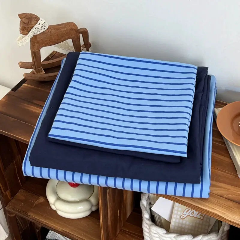 Bedding set with blue striped duvet cover and navy bedsheet